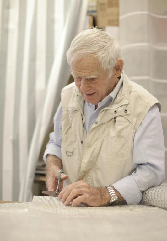 a man that is standing in front of a table, carving, sketching, dieter rams, herrarthstone