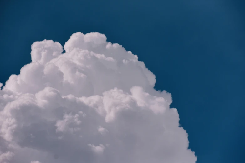 a jetliner flying through a cloudy blue sky, unsplash, magic realism, giant cumulonimbus cloud, cotton candy, ignant, portrait photo