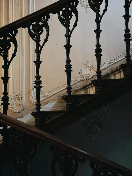 a close up of a staircase in a building, inspired by Elsa Bleda, pexels contest winner, rococo, gothic regal and tattered black, promo image, wooden trim, rococo color scheme