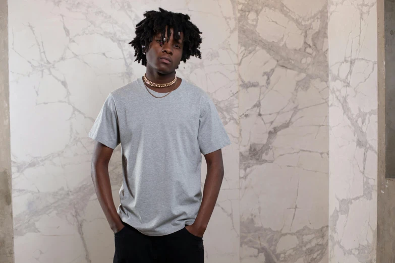 a man standing in front of a marble wall, by Nina Hamnett, visual art, plain white tshirt, chief keef, in gunmetal grey, male teenager