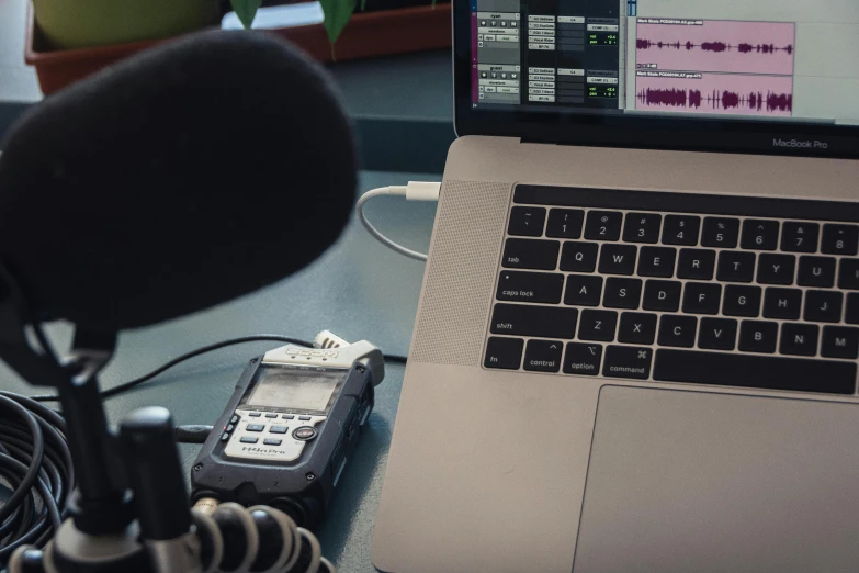 a laptop computer sitting on top of a desk next to a microphone, happening, multiple stories, thumbnail, radios, l7m