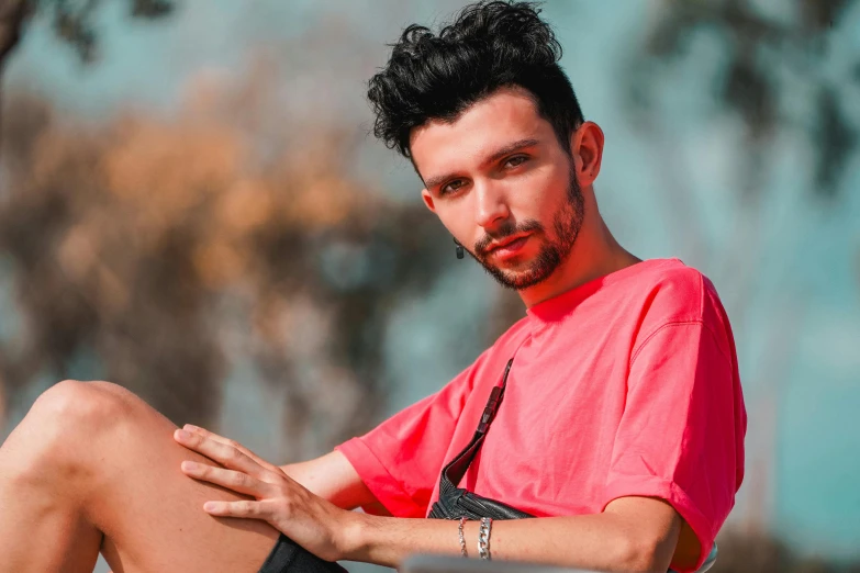 a man in a pink shirt is sitting on a skateboard, trending on pexels, hyperrealism, light stubble with red shirt, avatar image, middle eastern skin, androgynous person