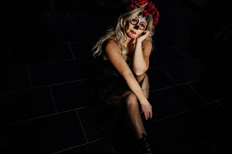 a woman sitting on a tiled floor wearing a mask, unsplash, lowbrow, jessica nigri face!!, the little circus of horrors, with a red halo over her head, with haunted eyes and glasses