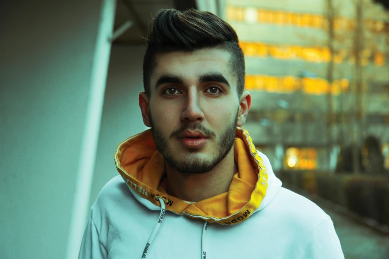 a close up of a person wearing a hoodie, inspired by Ion Andreescu, trending on pexels, attractive young man, youtuber, pompadour, ismail