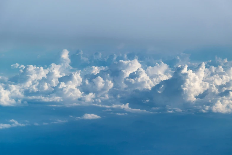 a blue sky filled with lots of white clouds, by Niko Henrichon, pexels contest winner, romanticism, high above the ground, close-up photograph, atmosphere hyperrealistic, high resolution