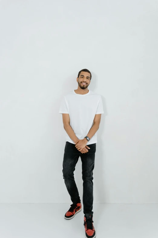 a man standing in front of a white wall, dressed in a white t-shirt, ismail, casually dressed, cleanest image