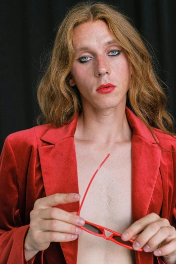 a woman in a red jacket holding a pair of scissors, inspired by Nan Goldin, renaissance, androgynous male, beth cavener, small breasts, red tie