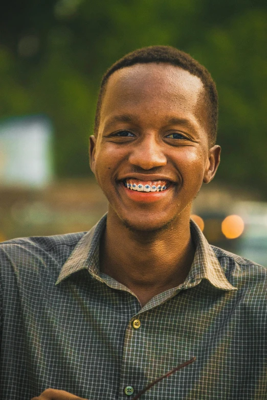a close up of a person holding a cell phone, an album cover, inspired by Ibram Lassaw, smile with large front teeth, young man with medium - length, wide forehead, profile pic