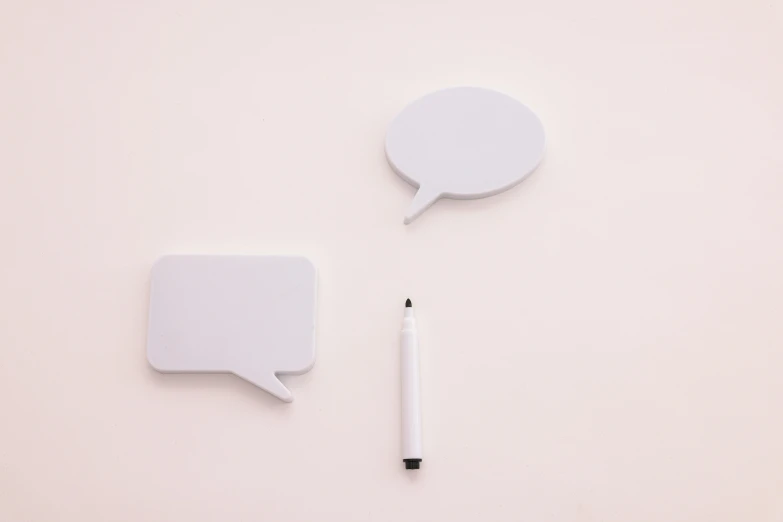two speech bubbles and a pencil on a white surface, by Emma Andijewska, minimalism, white plastic, beige, status icons, white