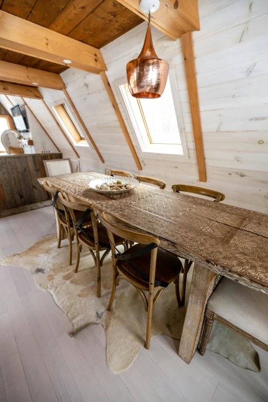 a dining room with a wooden table and chairs, by Jan Tengnagel, trending on unsplash, in an attic, wooden boat, dune style, richly textured