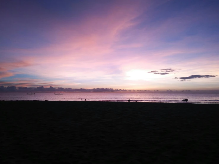 a group of people standing on top of a sandy beach, purple sunset, manila, photo of the middle of the ocean, today\'s featured photograph 4k