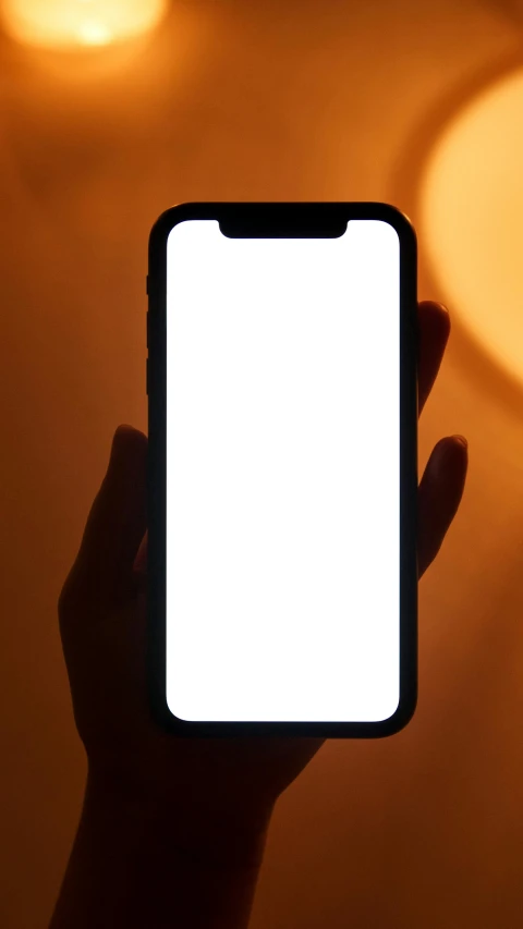 a person holding up a cell phone with a white screen, pexels, orange glow, beautiful iphone wallpaper, soft shadow transition, rounded corners