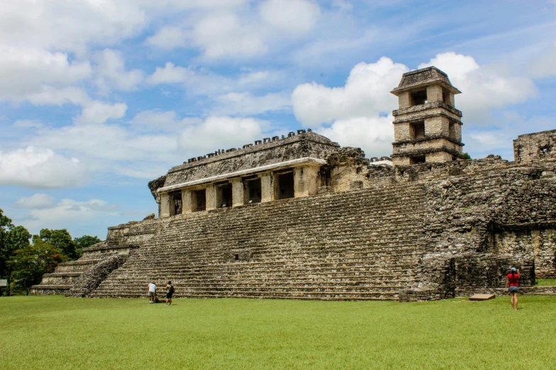 a large stone structure sitting on top of a lush green field, pacal votan, avatar image