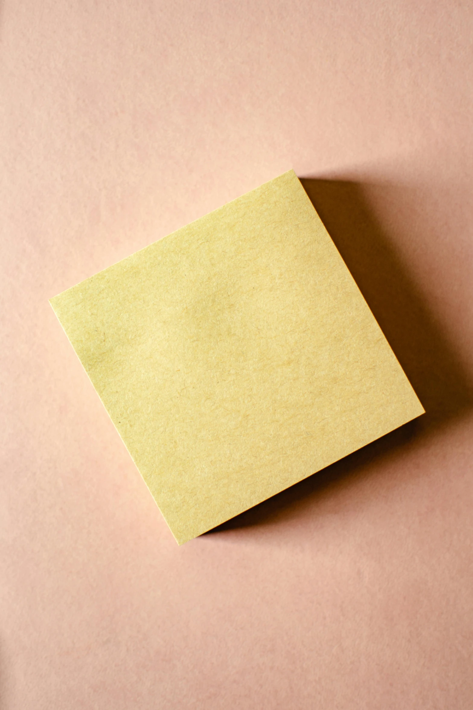 a piece of yellow paper sitting on top of a pink surface, thumbnail, square, very buff, detailed product image