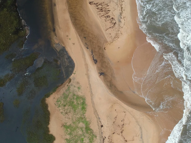 a bird's eye view of a sandy beach, pexels contest winner, hurufiyya, oil spill, light and dark, coastline, down there