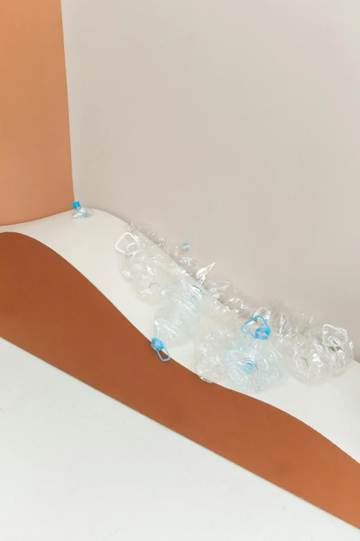 a piece of cardboard sitting on top of a table, floating crystals, cyan and orange, clear curvy details, yael shelbia