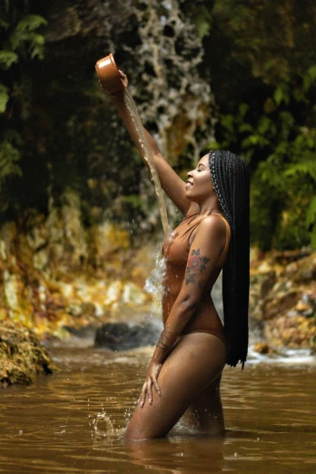 a woman that is standing in some water, with brown skin, waterfall backdrop, wearing shipibo tattoos, r&b