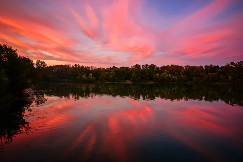 a sunset over a body of water with trees in the background, by Jan Rustem, pexels contest winner, pink and red colors, from wheaton illinois, wide angle river, cotton candy clouds