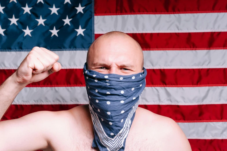 a bald man wearing a bandana in front of an american flag, inspired by Brian 'Chippy' Dugan, unsplash, american romanticism, getting ready to fight, bandoliers, sam hyde, mr clean