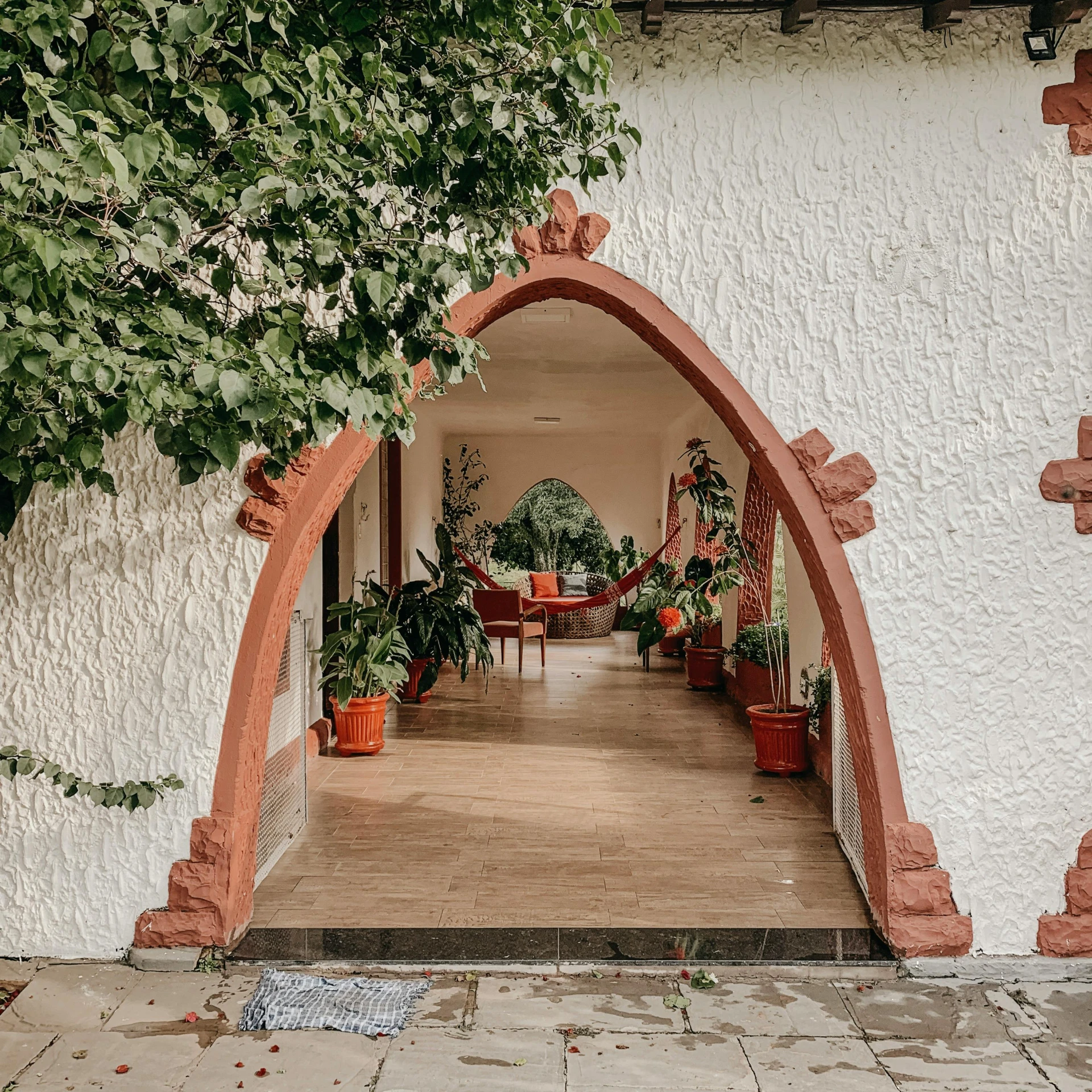 a doorway leading to a patio with potted plants, by Daniel Lieske, pexels contest winner, art nouveau, white sweeping arches, health spa and meditation center, neo - andean architecture, inter dimensional villa