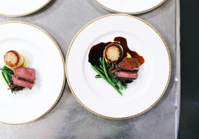 a close up of plates of food on a table, inspired by Charles Le Roux, beef, sydney hanson, lined up horizontally, 3delight