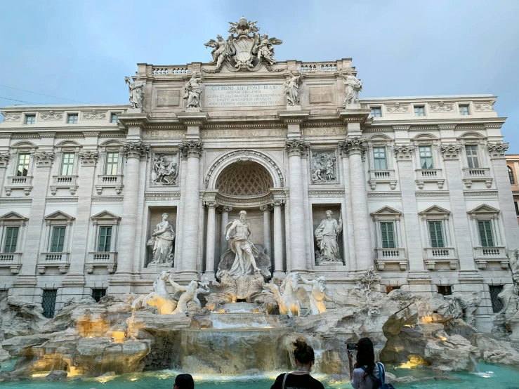 a group of people standing in front of a fountain, a marble sculpture, avatar image