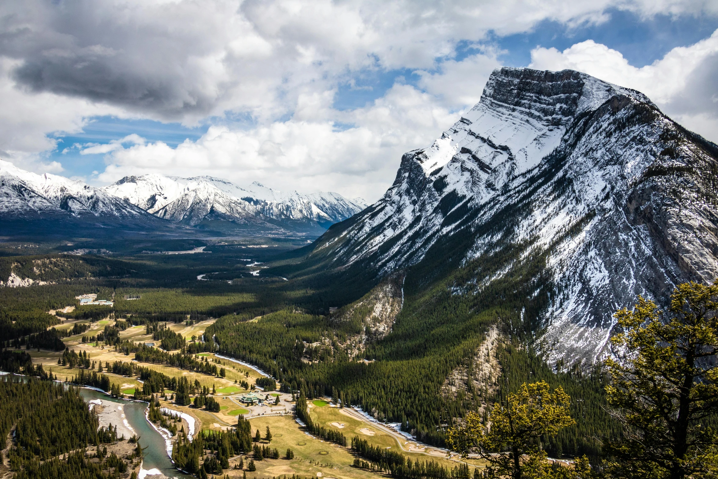 a view of a valley with mountains in the background, by Brigette Barrager, pexels contest winner, banff national park, conde nast traveler photo, high cliff, wide high angle view