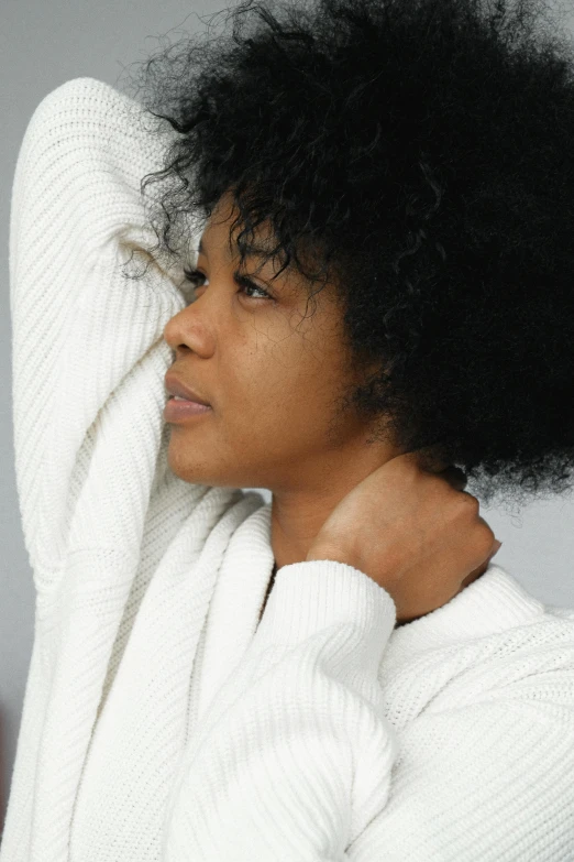 a woman in a bathrobe brushing her hair, trending on pexels, renaissance, arm around her neck, black young woman, portrait of mournful, wearing a white sweater