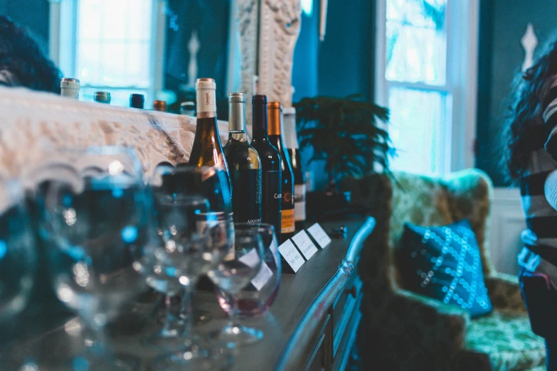 a man sitting at a bar drinking a glass of wine, pexels contest winner, renaissance, home display, maroon and blue accents, event, bottles