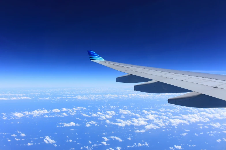 the wing of an airplane flying above the clouds, pexels contest winner, blue print, synthetic materials, avatar image, thumbnail