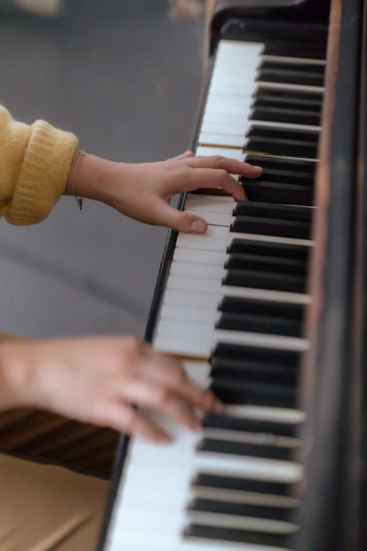 a close up of a person playing a piano