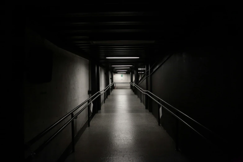 a black and white photo of a long hallway, inspired by Elsa Bleda, unsplash, dark underground, taken with sony alpha 9, stairway, empty space