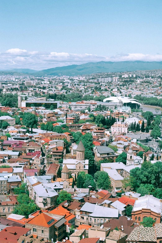 a view of a city from the top of a building, georgic, color photograph, 1990s photograph, 4k image