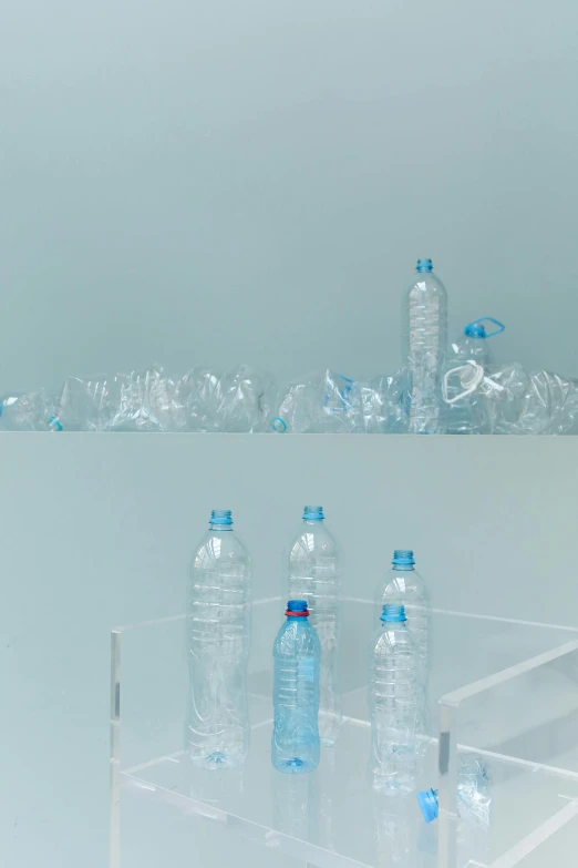 a group of water bottles sitting on top of a clear shelf, by Matija Jama, plasticien, motion still, made out of plastic, promo image, 2010s