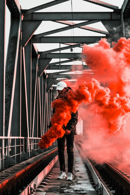 a man standing on a train track with red smoke coming out of his mouth, pexels contest winner, graffiti, gradient red to black, (smoke), police sirens in smoke, colors red