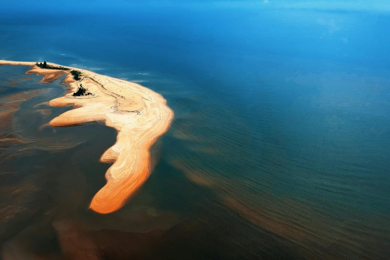 an island in the middle of a body of water, pexels contest winner, land art, sandy colours, flight, soft skin, slide show