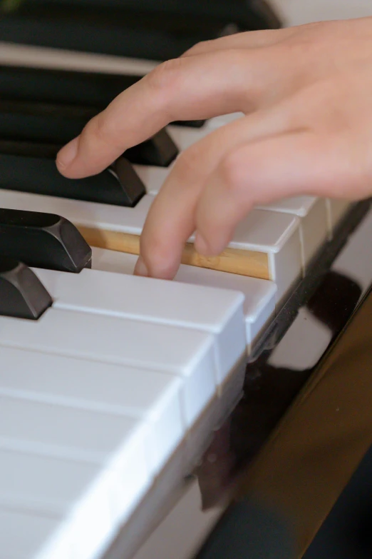 a close up of a person playing a piano