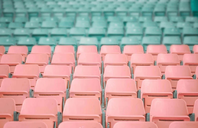 a group of pink chairs sitting next to each other, inspired by Andreas Gursky, trending on unsplash, color field, baseball stadium, teal orange, pale pastel colours, theatrical