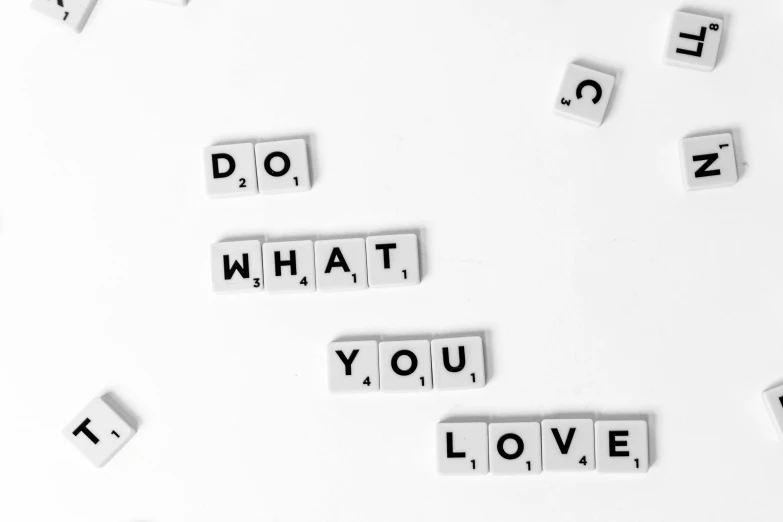 the words do what you love spelled in scrabbles, a black and white photo, by Matija Jama, pexels, white background wall, squares, listing image, body