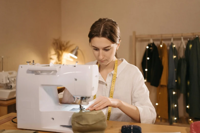 a woman is working on a sewing machine, by Julia Pishtar, trending on pexels, avatar image, full body image, round format, thumbnail