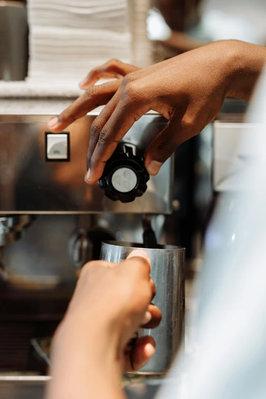 a person using a coffee machine in a kitchen, up close, collaboration, thumbnail, polished