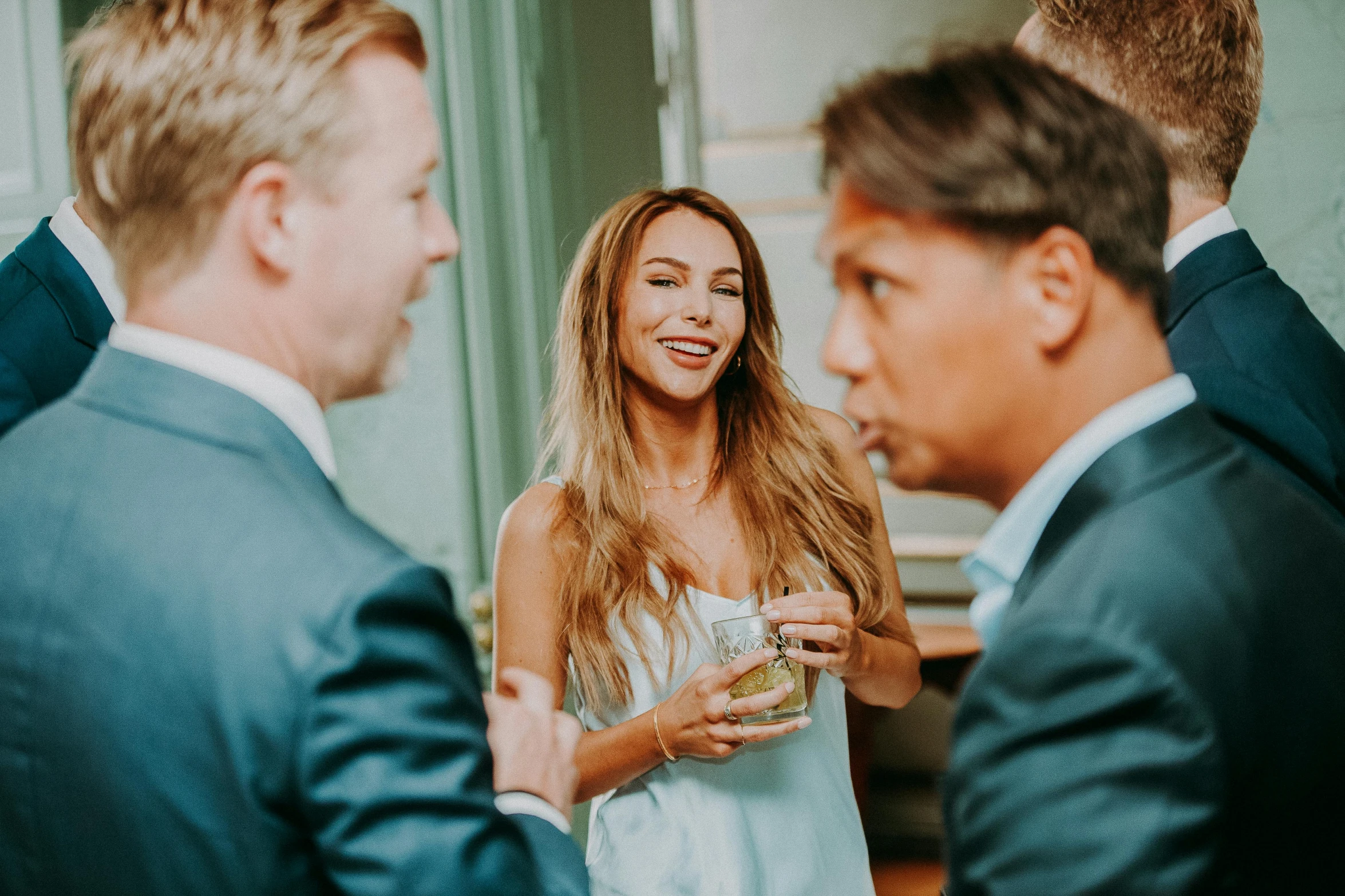 a group of people standing next to each other, by Emma Andijewska, pexels contest winner, happening, wearing a cocktail dress, flirting smiling, thumbnail, gentlemens dinner