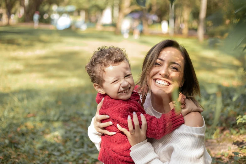 a woman holding a small child in a park, pexels contest winner, goofy smile, avatar image, full frame image, super high resolution