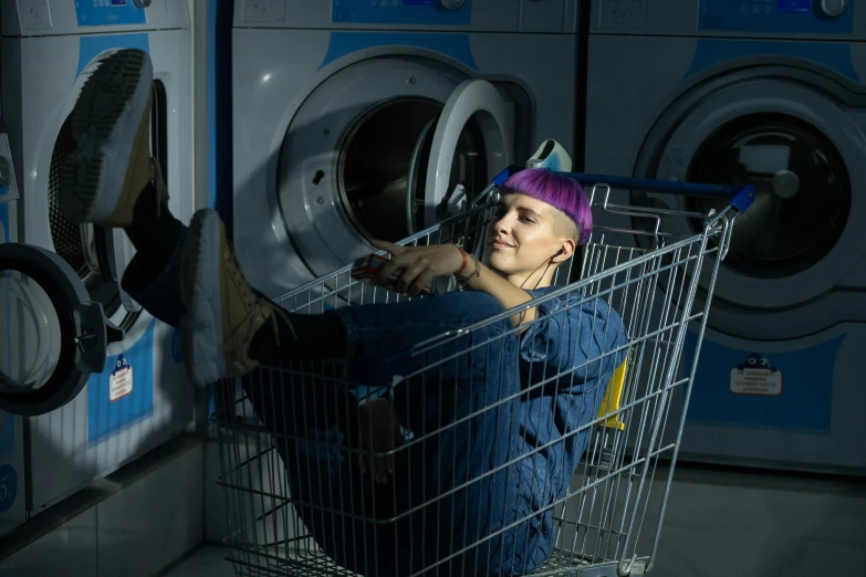 a woman sitting in a shopping cart in front of a washing machine, inspired by Elsa Bleda, pexels contest winner, renaissance, die antwoord ( yolandi visser ), non-binary, 15081959 21121991 01012000 4k, wearing plumber uniform