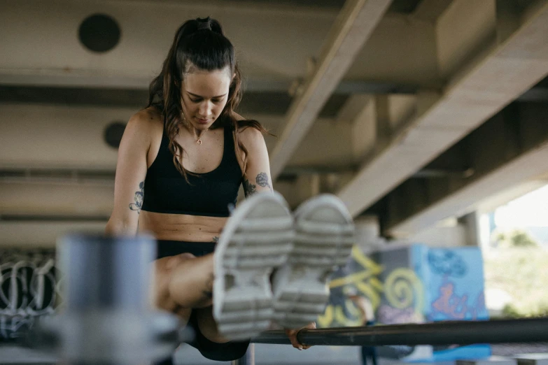 a woman sitting on top of a bench next to a skateboard, pexels contest winner, in a gym, serving body, sydney park, thumbnail