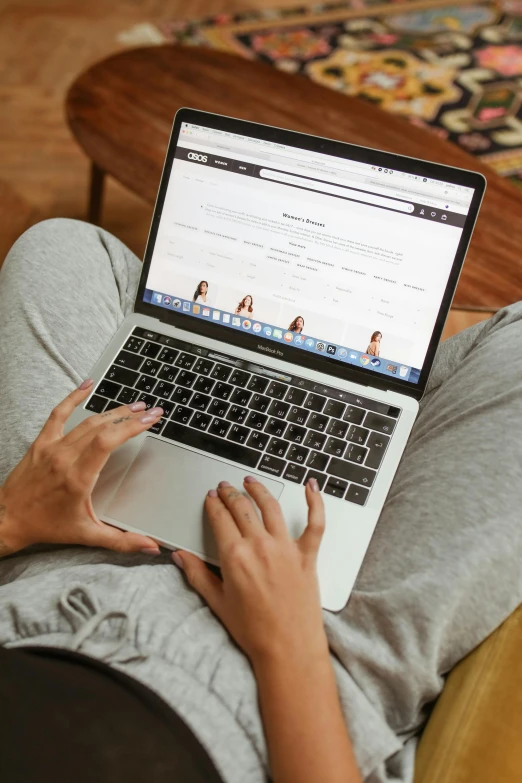 a woman sitting on a couch using a laptop computer, trending on pexels, top-down shot, 6 : 3 0 am, sports photo, student