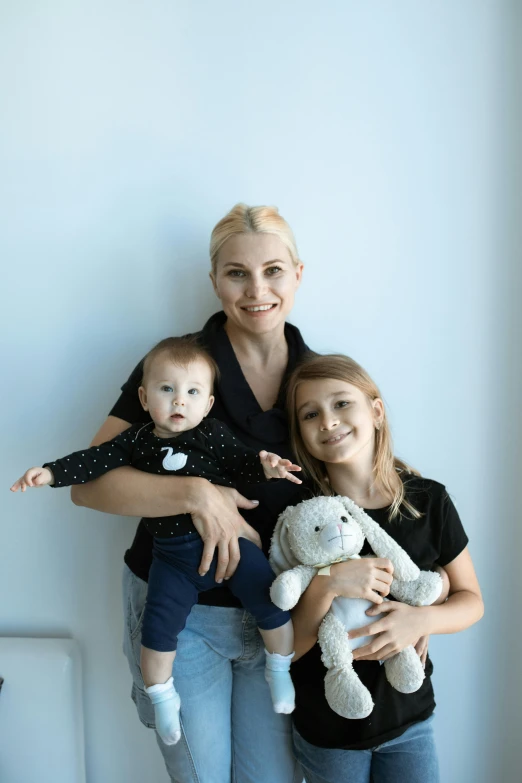 a woman and two children posing for a picture, a picture, by Silvia Dimitrova, corporate photo, plushy, eva elfie, medical image