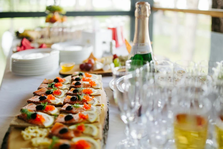 a table that has a bunch of food on it, a photo, pexels, renaissance, drinking champagne, overflowing feast buffet table, looking across the shoulder, clean and simple