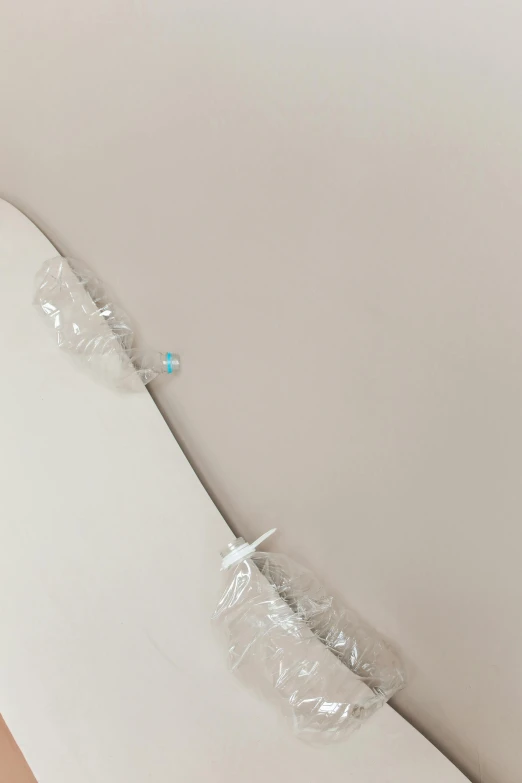 a snowboard sitting on top of a wooden floor, inspired by Lucio Fontana, unsplash, conceptual art, wearing organza gown, surgical iv drip, detail shot, white bed