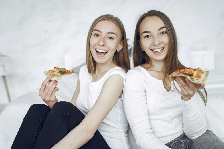 two women sitting on a bed eating pizza, pexels contest winner, avatar image, high school girls, with a white background, alina ivanchenko